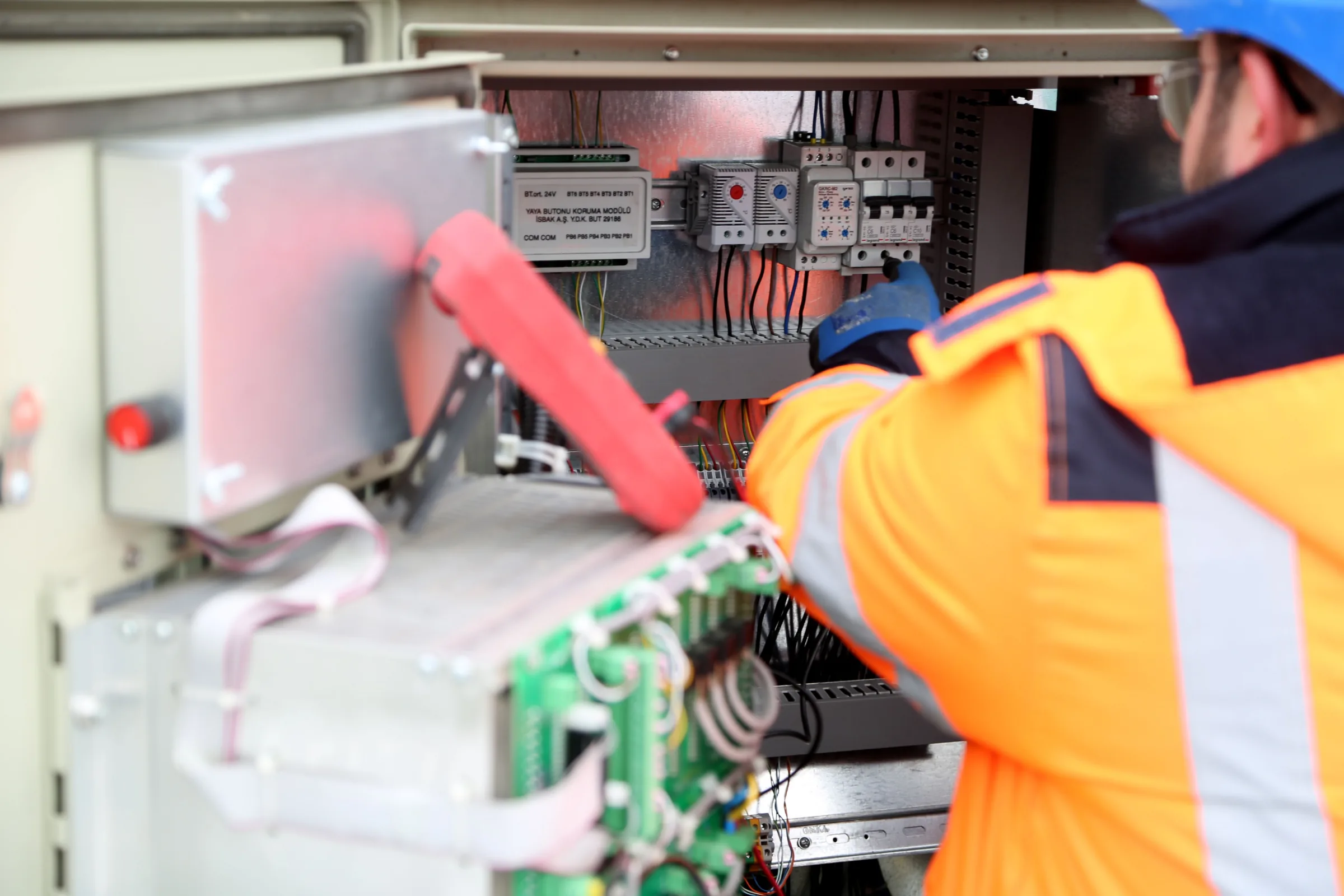 Temporary illustrative image of an electrician working on commercial electrical equipment