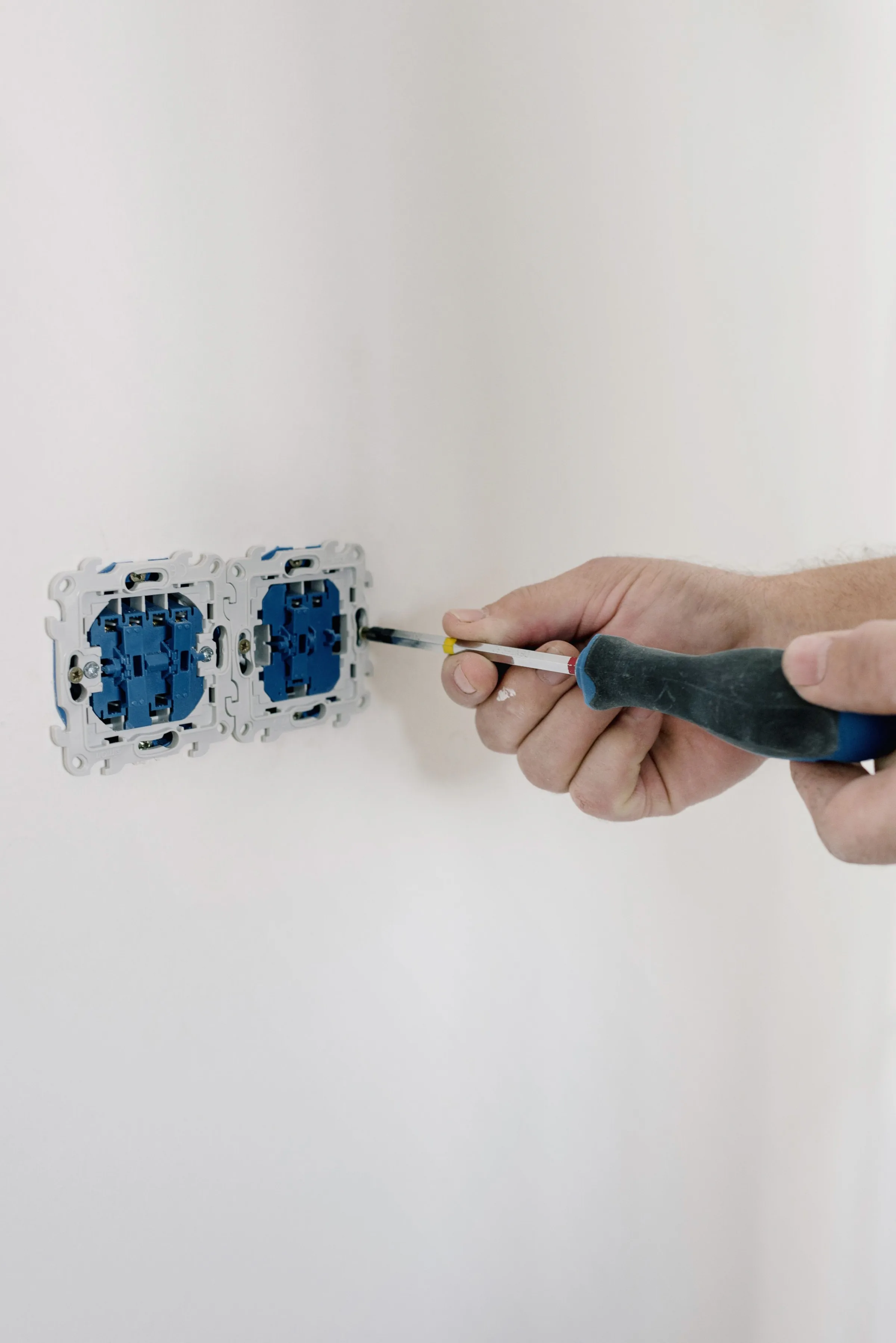 Electrician installing a residential wall outlet